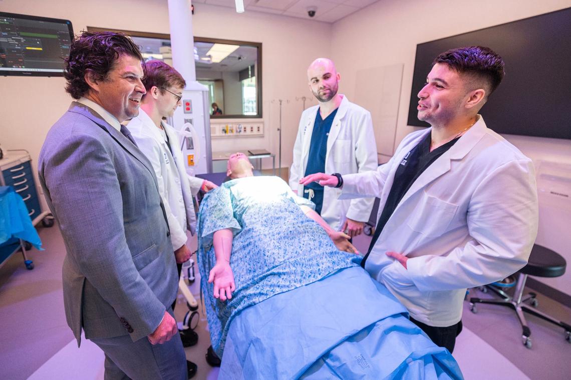 TCU President Daniel Pullin watches first-year medical students Mason Runkel, second from left, Stephen Pullman, second from right, and Bijan Hosseini work on the mannequin in a simulation lab at the TCU Burnett School of Medicine in Fort Worth on Tuesday, Sept. 17, 2024.