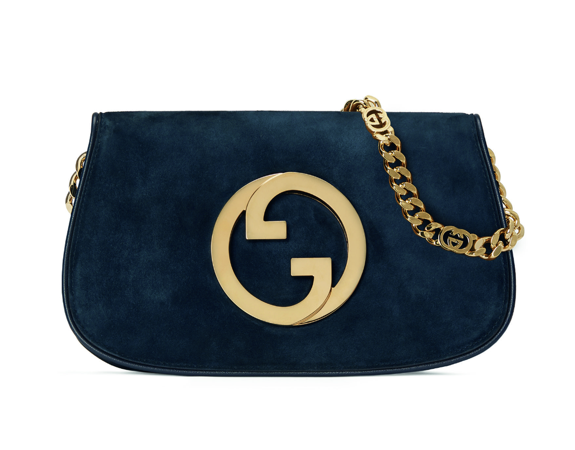 An image of a blue Gucci handbag shows a gold buckle and chain.