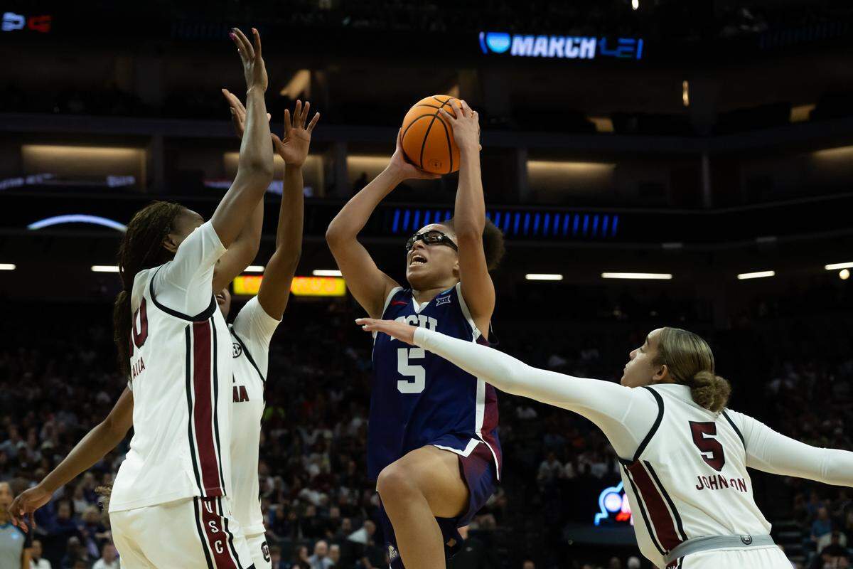 TCU guard Olivia Miles (5) drives to the basket against South Carolina forward Maryam Dauda (30), forward Joyce Edwards and guard Tessa Johnson (5) in the Elite Eight of the NCAA Tournament on Monday at Golden 1 Center in Sacramento, Calif.