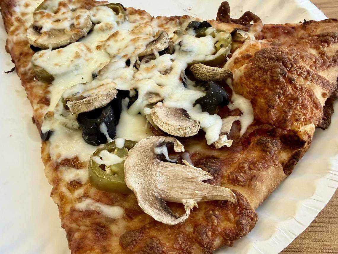 A pizza slice with jalapenos, olives and mushrooms at Kabylo’s Pizza by the Slice in North Richland Hills, Texas, seen Jan. 11, 2026.