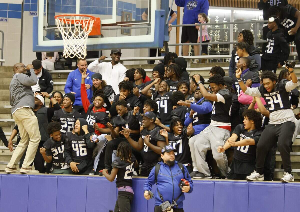 North Crowley football team celebrate their girl basketball team against Allen during the second half of a UIL Class 6A Division I girls regional semifinals basketball playoff game at Grand Prairie High School in Grand Prairie, Texas, Tuesday Feb. 24, 2026.