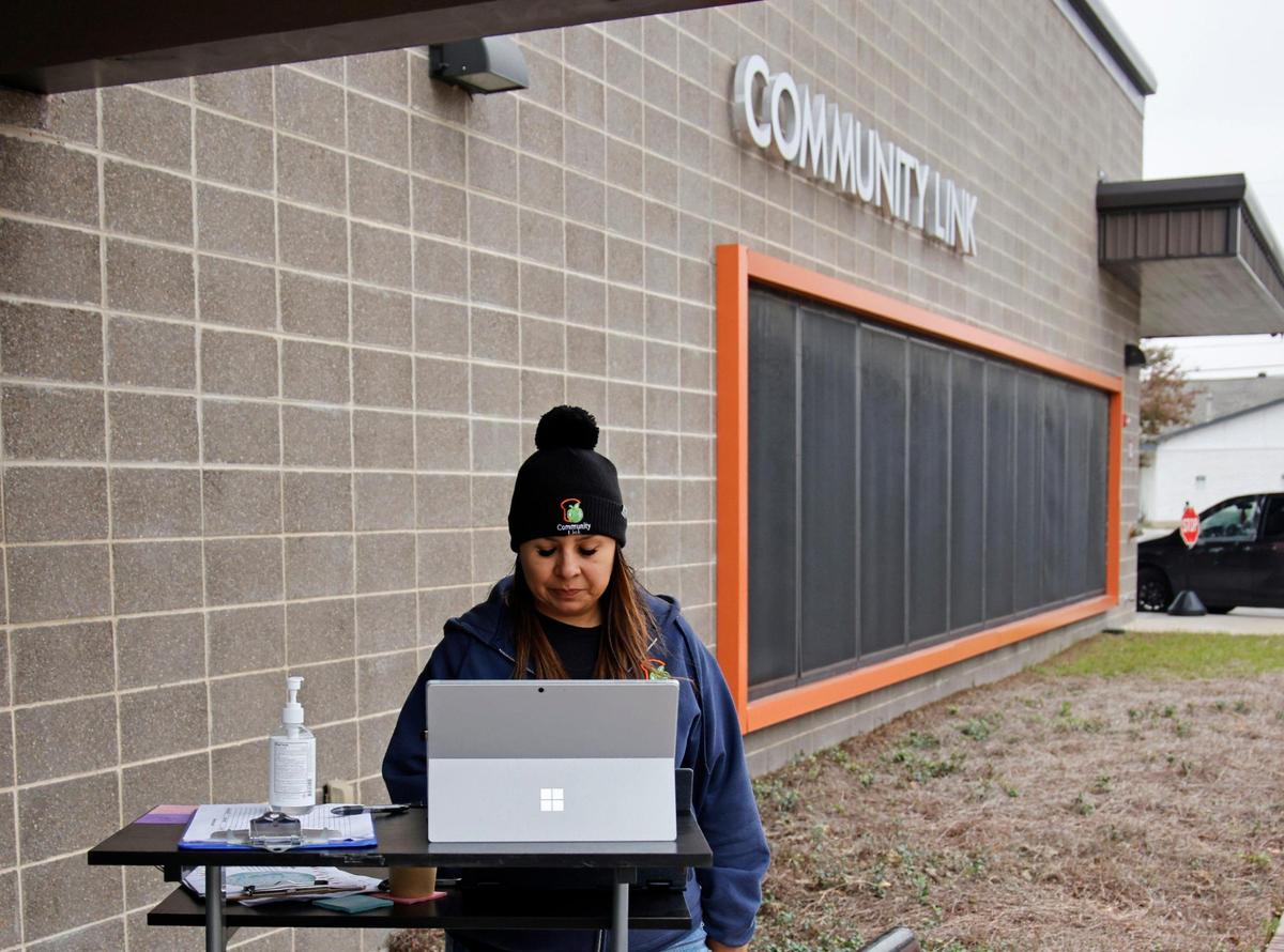 Carolina Castillo checks her records for food pickup at Community Link in Saginaw, Texas, Thursday, Nov. 16, 2023. They handed out meals for 143 families while turning away more than they served. (Special to the Star-Telegram Bob Booth)