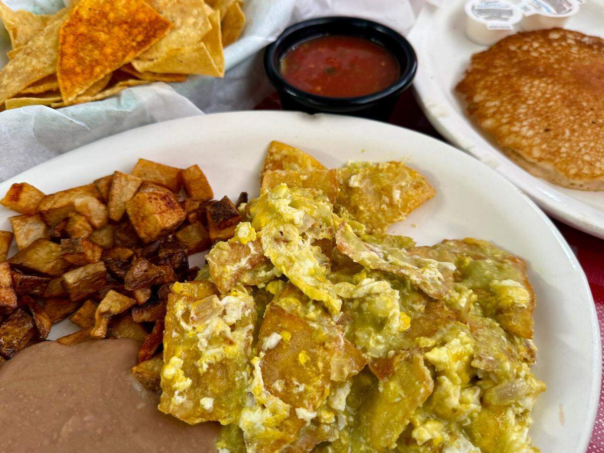 Chilaquiles verdes with eggs. potatoes, beans and a pancake at Bigotes Mexican Restaurant in Arlington, Dec. 1, 2024.