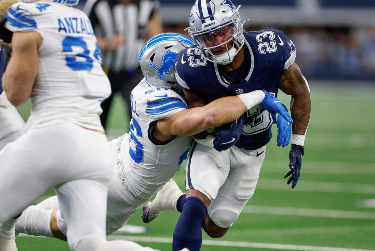 Dallas Cowboys running back Rico Dowdle is tackled by Detroit Lions linebacker Jack Campbell on Sunday, Oct. 13, 2024, at AT&T Stadium in Arlington.
