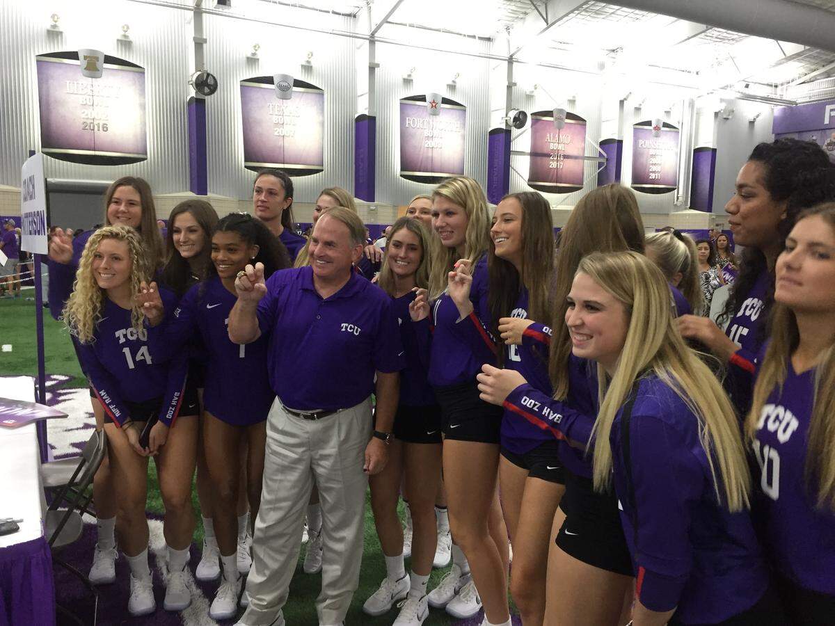 TCU coach Gary Patterson takes a photo with the volleyball team.