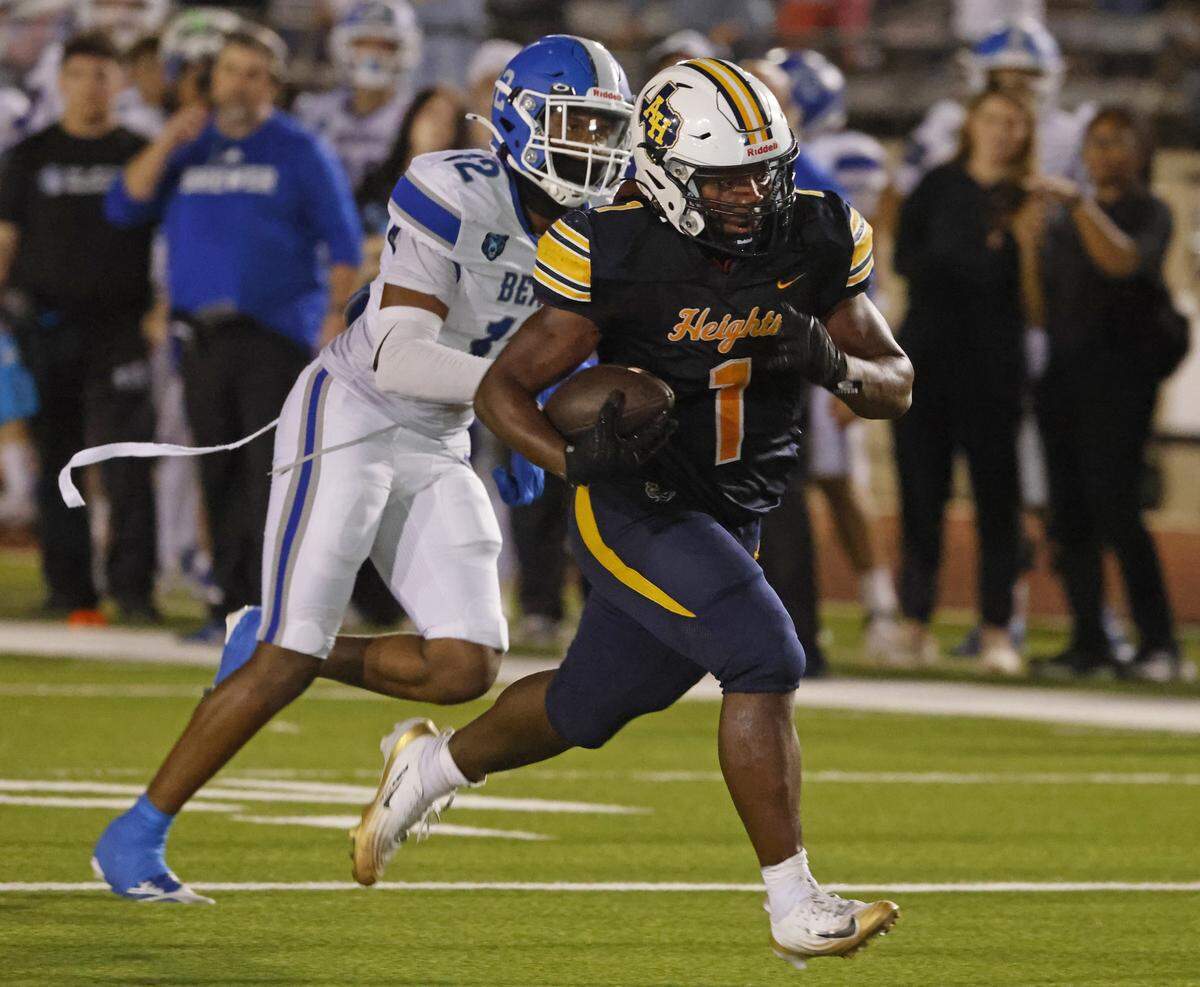 Arlington Heights running back Carson James beats Brewer cornerback Jaiden Carrigan to the end zone during the second half of their Class 5A Division I bi-district playoff game Nov. 14 at Farrington Field.