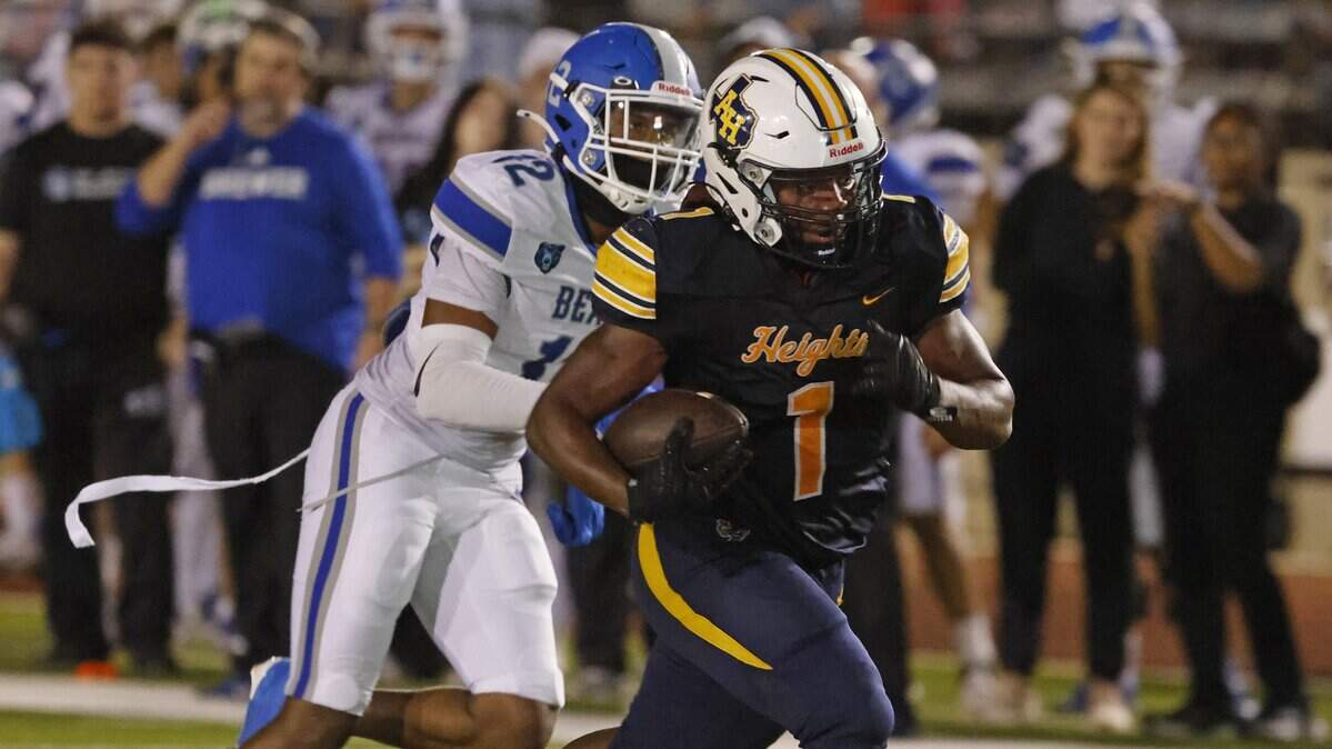 Arlington Heights running back Carson James (1) beats Brewer cornerback Jaiden Carrigan (12) to the end zone during the second half of a UIL Conference 5A D1 Bi-District playoff game between Arlington Heights and Brewer at Farrington Field in Fort Worth, Texas, Friday, Nov. 14, 2025.
