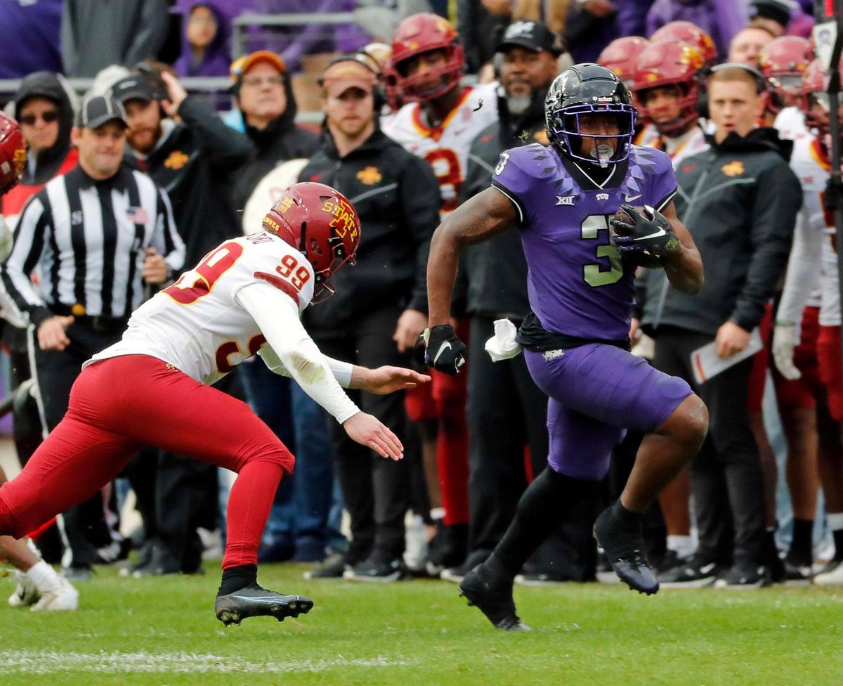 TCU running back Emari Demercado runs past Iowa State defensive lineman Howard Brown at Amon G. Carter Stadium on Nov. 26.