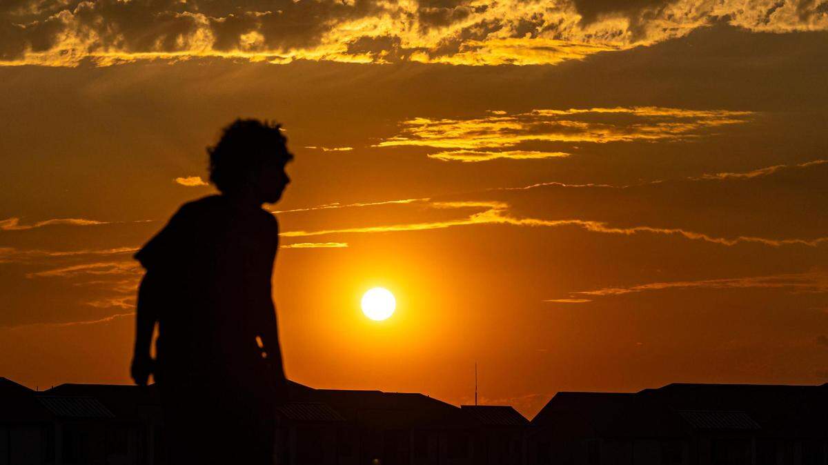 A skater is silhouetted as the sun begins to set at Chisholm Trail Skate Park in Fort Worth on Tuesday, Aug. 29, 2023.