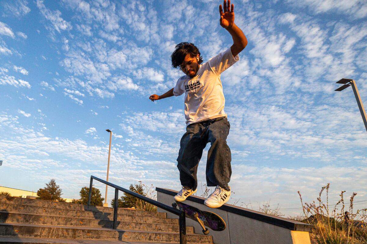 Martin “Tini” Tijerina skates down a railing at sunset at Chisholm Trail Skate Park in Fort Worth on Tuesday, Aug. 29, 2023.