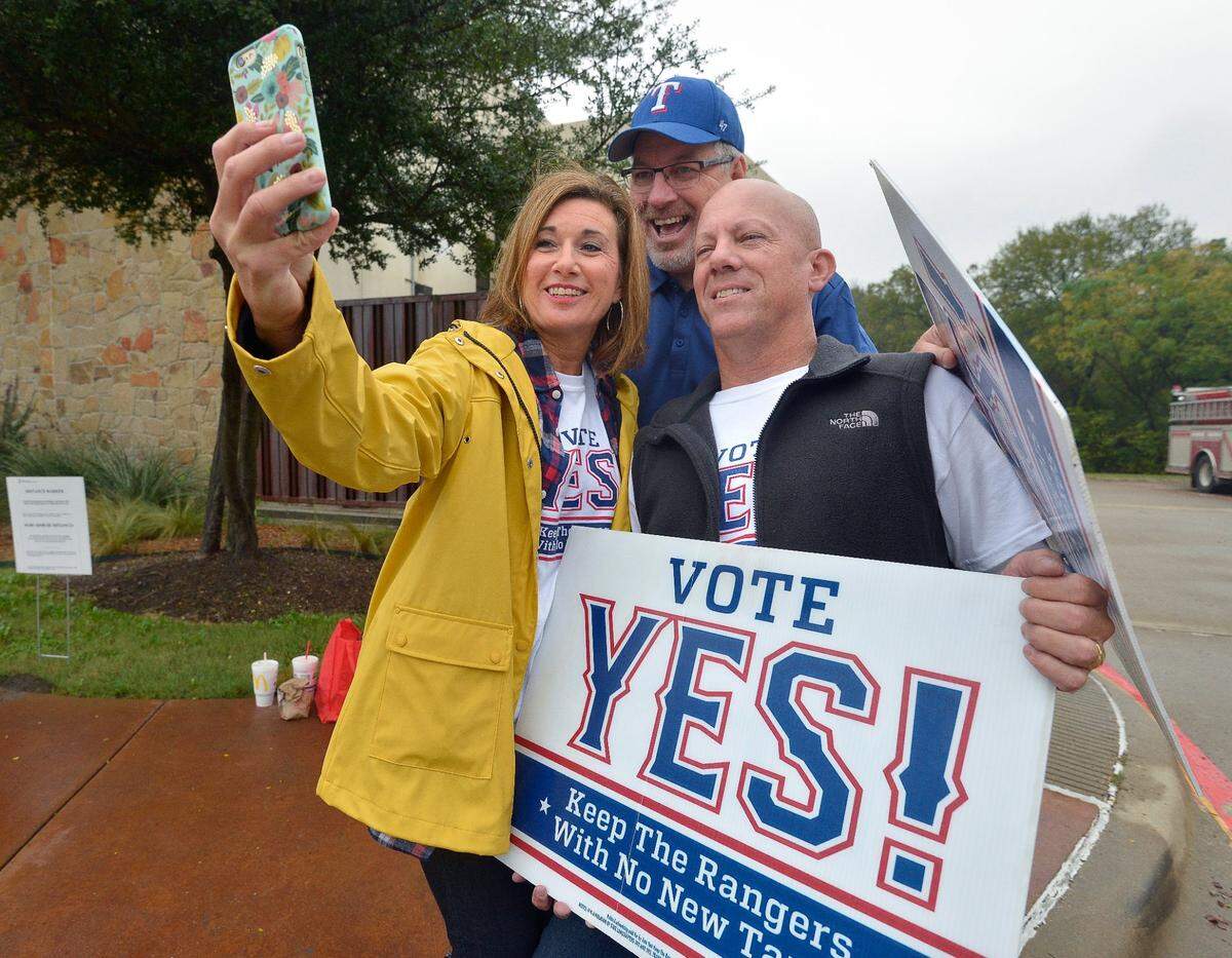 Nov. 8, 2016: Supporters of a bond measure to build a new Texas Rangers stadium. Becky Berry, husband Andy Berry and former council member Wayne Ogle, center, take a moment for a selfie during their campaign outside of the Elzie Odom Rec Center on election day in Arlington.