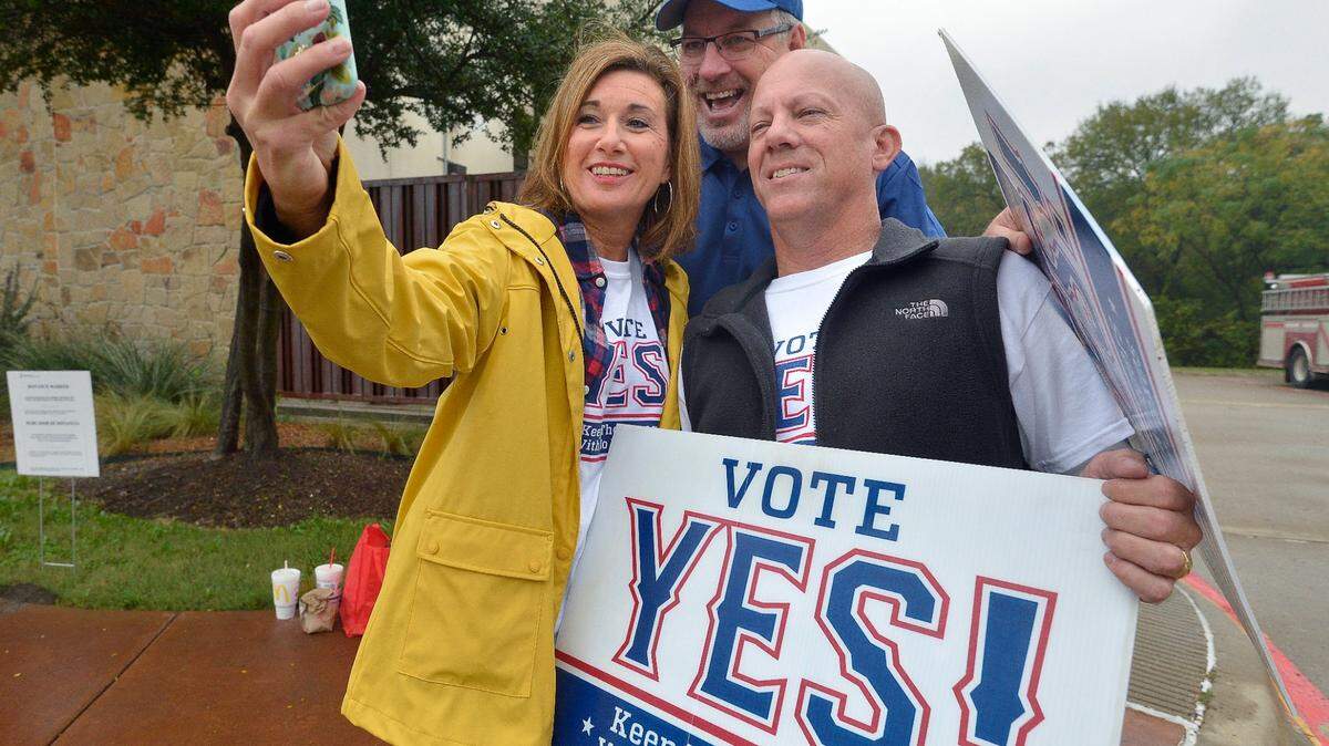 Nov. 8, 2016: Supporters of a bond measure to build a new Texas Rangers stadium. Becky Berry, husband Andy Berry and former council member Wayne Ogle, center, take a moment for a selfie during their campaign outside of the Elzie Odom Rec Center on election day in Arlington.