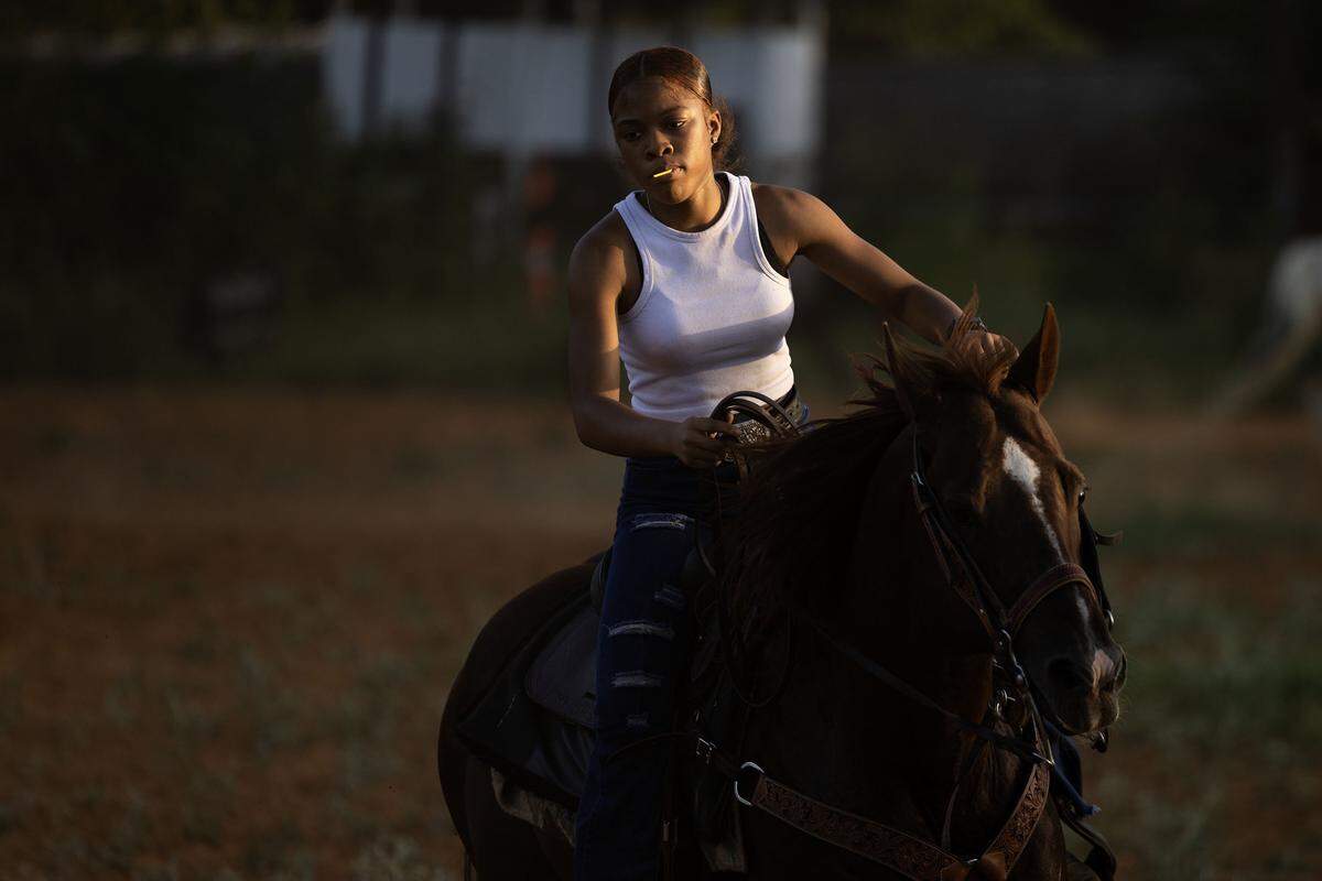 Fort Worth native Louis Scott, 17, rides her horse Charlie Boy during Circle L5 drill team practice at Papa Doddie Arena in east Fort Worth. At 17, Scott is the youngest member of the team. 