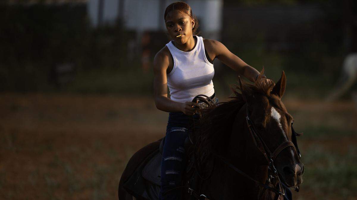 Fort Worth native Louis Scott, 17, rides her horse Charlie Boy during Circle L5 drill team practice at Papa Doddie Arena in east Fort Worth. At 17, Scott is the youngest member of the team. 