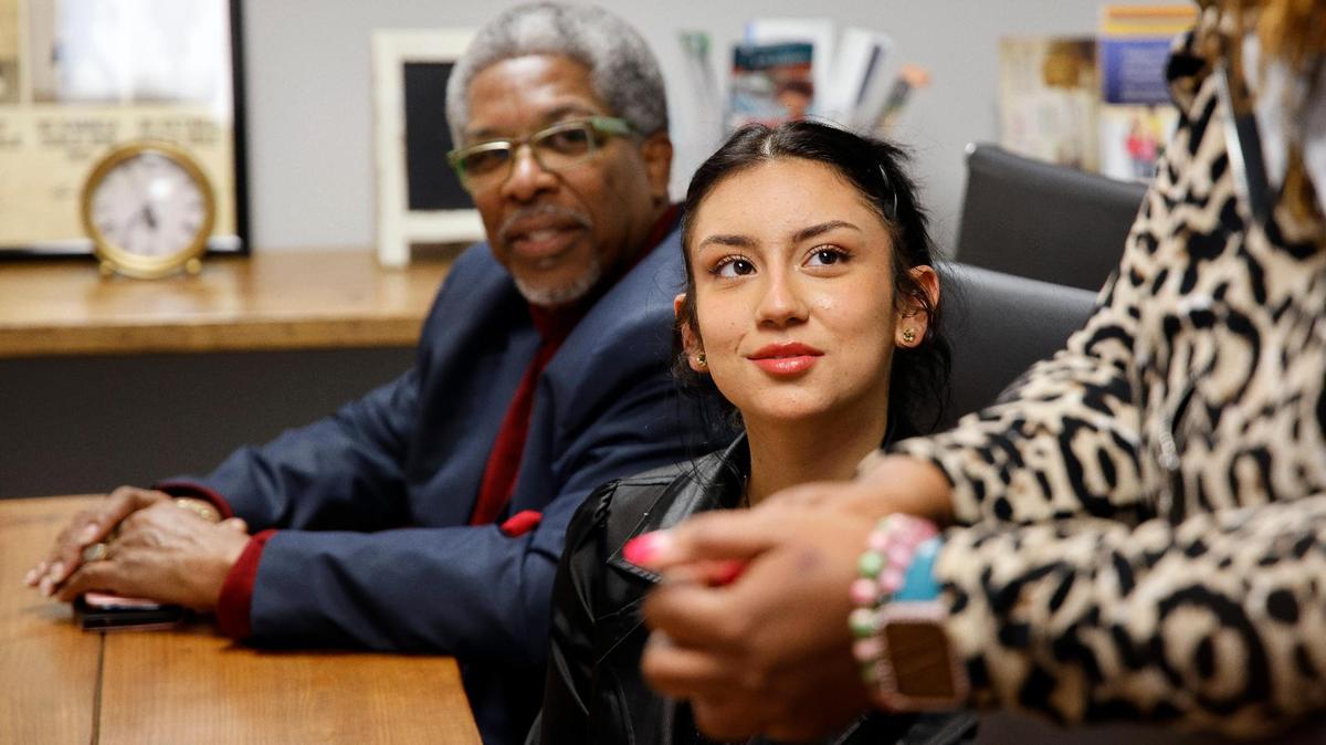 Grace, 16, center, a participant in the Youth Advocate Programs, and VJ Smith, left, an advocate with the program, listen to criminal defense attorney MarQuetta A. Clayton during a meeting in April. The program works with children in the juvenile justice system as an alternative to detention.