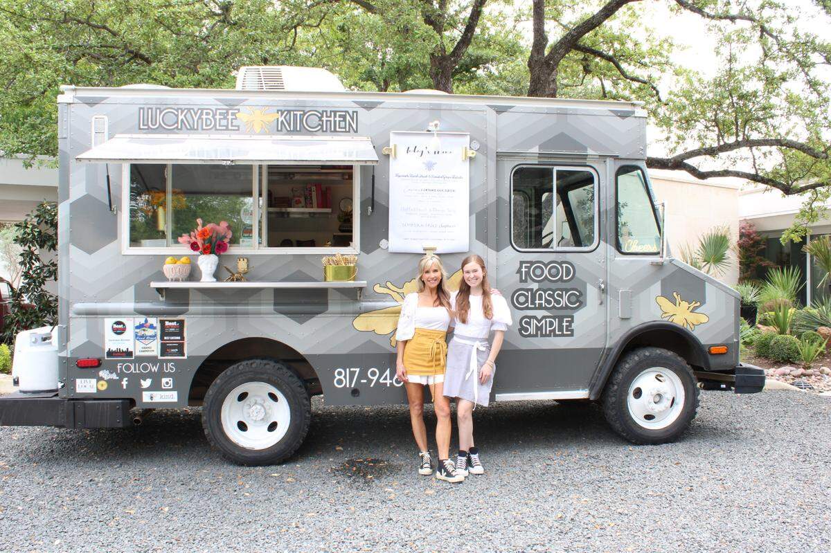 Jenny Castor, left, owner of Luckybee Kitchen, and daughter Albany Castor stand in front of the food truck in Fort Worth on April 18, 2024. The two usually work lunch catering events together.