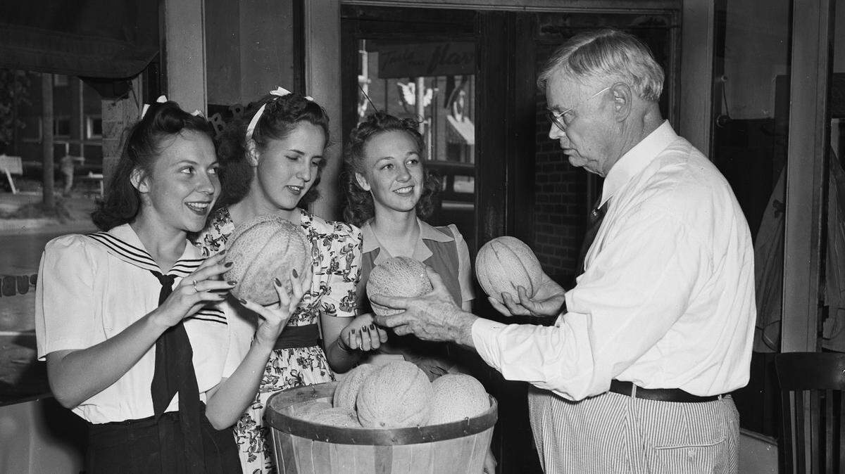 July 10, 1941: Grapevine Mayor B. B. Wall, presenting cantaloupes to out-of-town guests at the Cantaloupe Festival. From left, Misses Jane Mangold, Granbury; and Betty Jo Quillin and Edith Lipscomb, Houston.