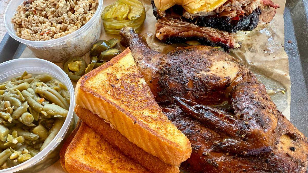 A half smoked chicken with a brisket sandwich, top, and green beans and “filthy” dirty rice (made with chicken and turkey) at Hump’s BBQ in Pantego, Texas, June 9, 2025.