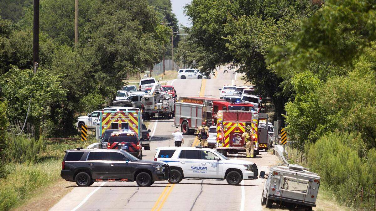 Law enforcement agencies, including Tarrant County Sheriff’s Office, block a section of Morris Dido Newark Road as they work an active scene nearby on Thursday, June 23, 2022.A suspect opened fire after deputies attempted to serve a felony warrant earlier in the morning.