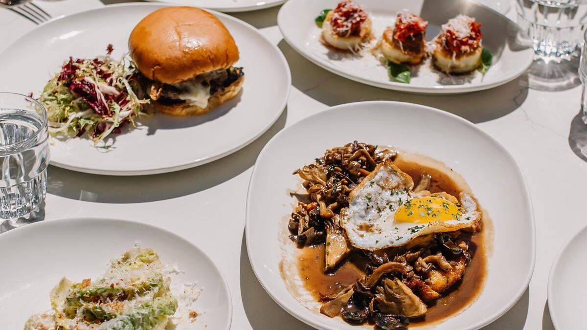 A dinner appetizer of wild mushrooms with a duck egg and ricotta at Caterina’s, along with a Caesar, a lunch double cheeseburger and a simple caprese.