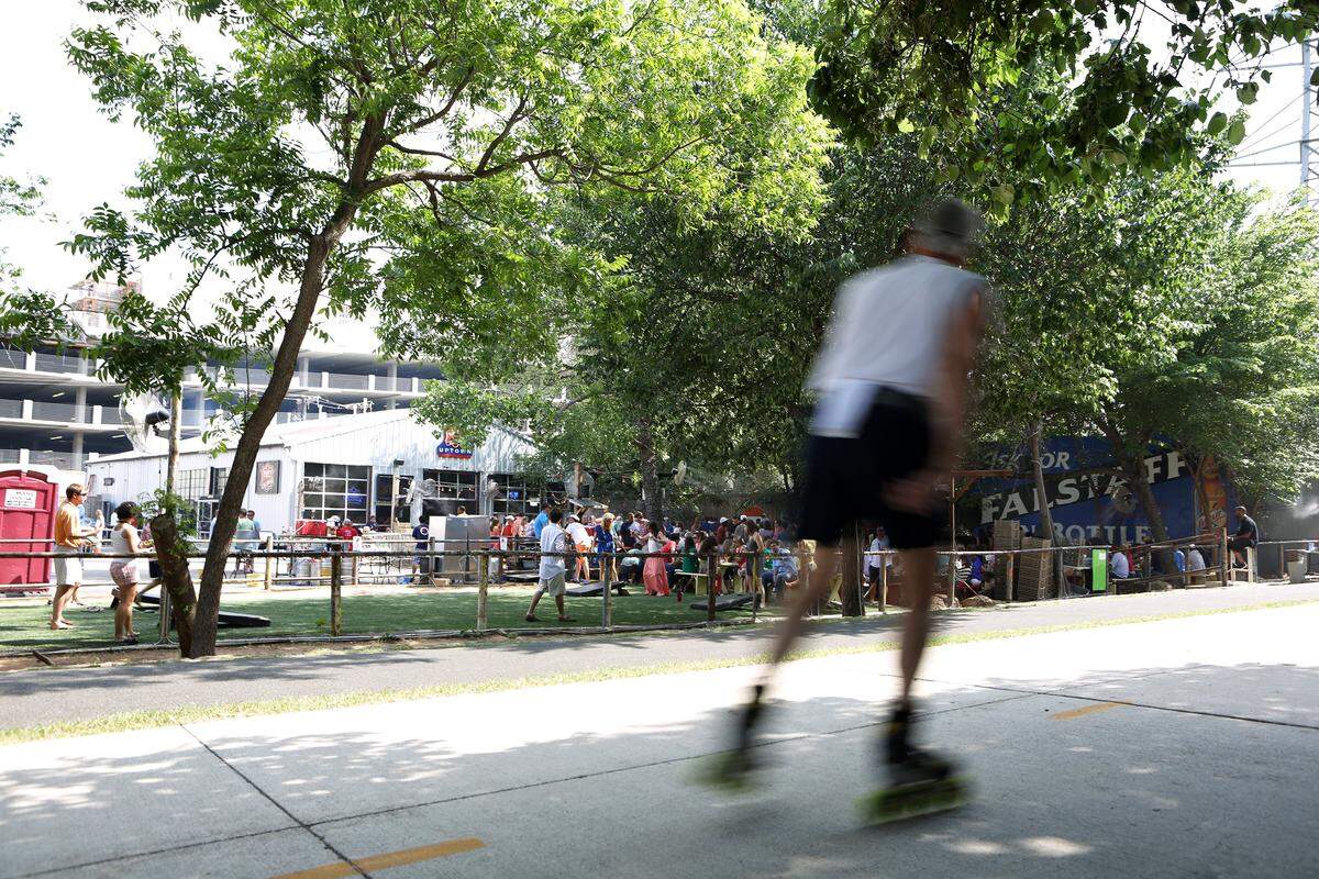 A rollerblader skates past the patio area April 28, 2012, at the Katy Trail Ice House in Dallas.