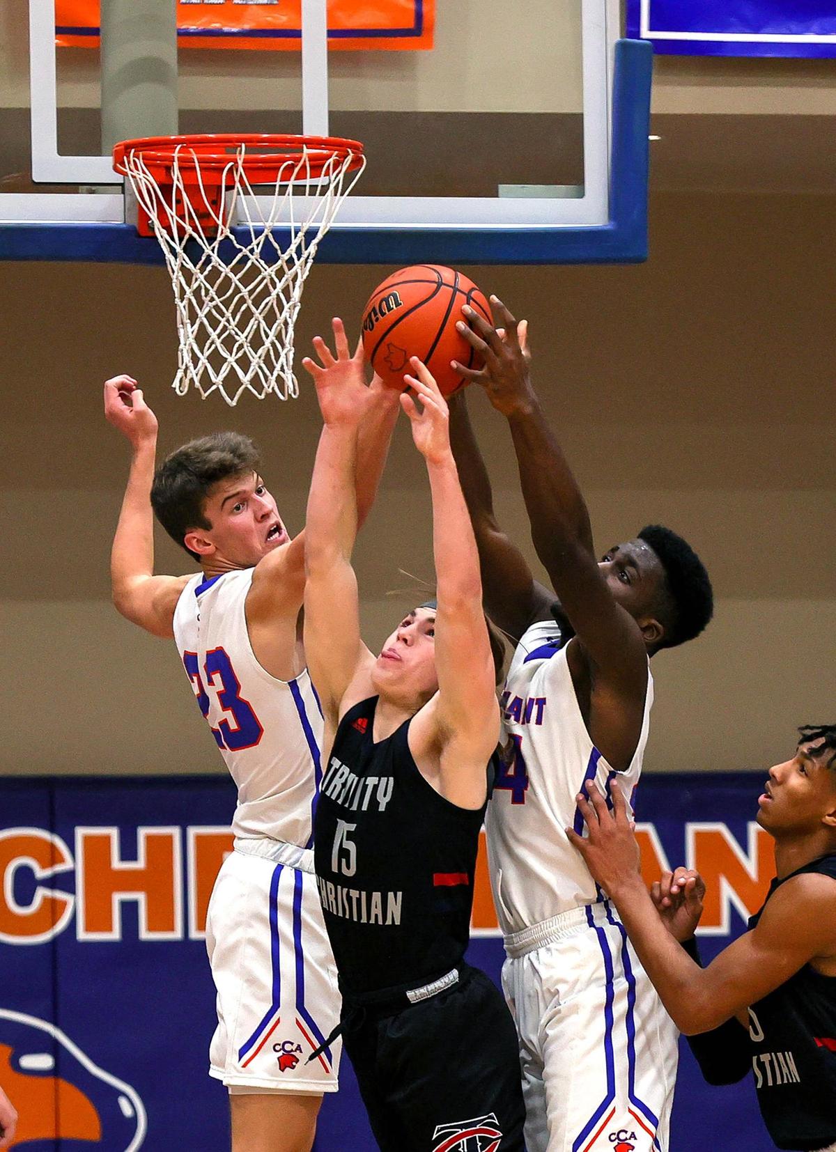 Colleyville Convenant forward Austin Scheets (23) and forward Enow Etta (R) go for a rebound against Lubbock Trinity Davis Reeves (15) during the first half of a High School Basketball game played at Colleyville Convenant High School, January 29, 2021. (Steve Nurenberg Special to the Star-Telegram)