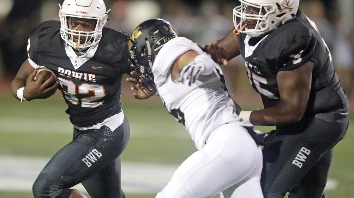 Bowie running back Marsaillus Sims (32) clears the right side of the line for a short gain as Mansfield played Bowie in a high school football game at Wilemon Stadium Friday September 07, 2018. The game was rain-delayed by over 45 minutes.