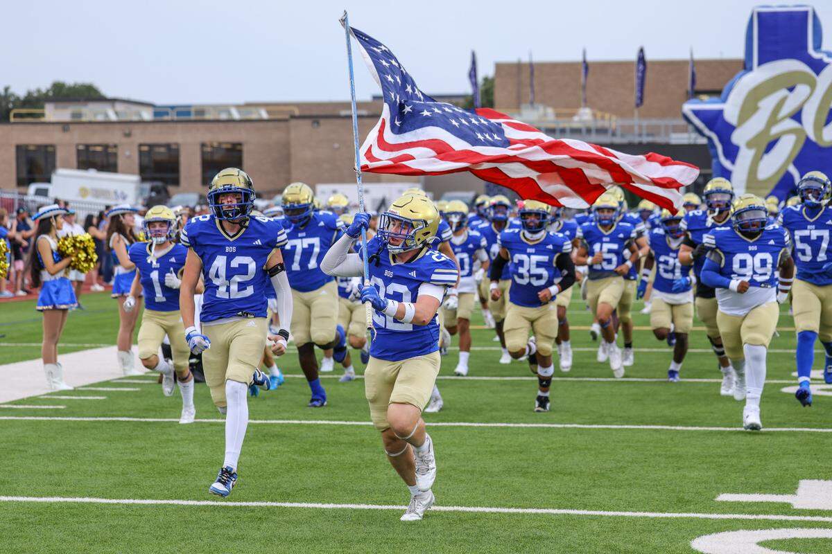 The Boswell football team runs onto the field before the game against Saginaw at Boswell Pioneer Stadium on Friday, Sept. 5, 2025.