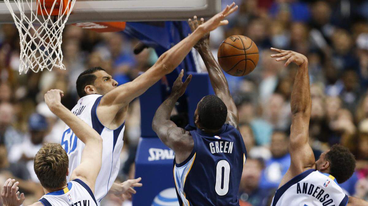 Dallas Mavericks center Salah Mejri (50) blocks a shot by Memphis Grizzlies forward JaMychal Green (0) as teammates Justin Anderson (1) and Dirk Nowitzki (41) guard during the first half of a NBA basketball game, Friday, April 8, 2016, in Dallas.
