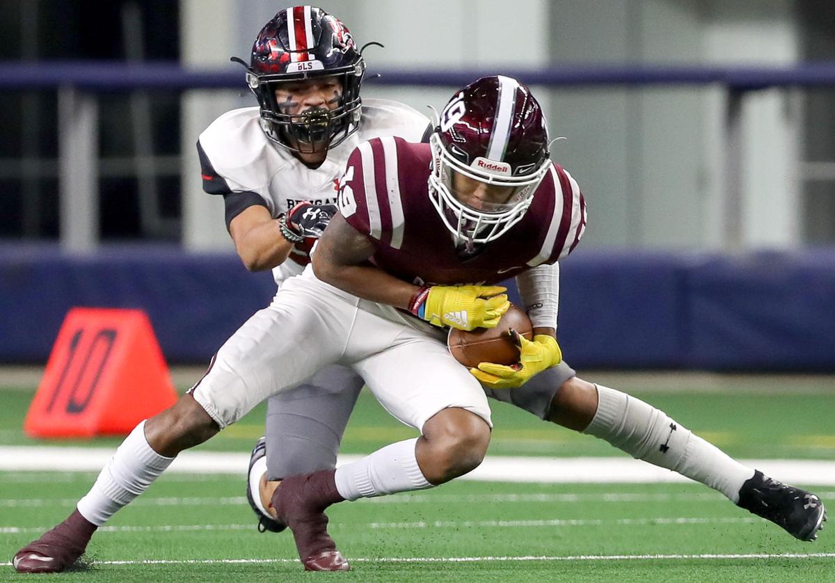 Red Oak wide receiver Coby Cavil (19) makes a reception against Denton Braswell defensive back Dre Young (33) during the first half of their 5A Division II area round high school football playoff game at AT&T Stadium in Arlington, Tx Saturday November 23, 2019.
