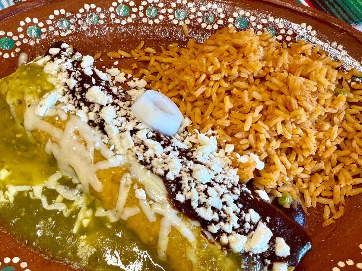 A chicken mole enchilada (enmolada) and a green chicken enchilada at La Casa de Lina in Fort Worth, seen April 21, 2025.