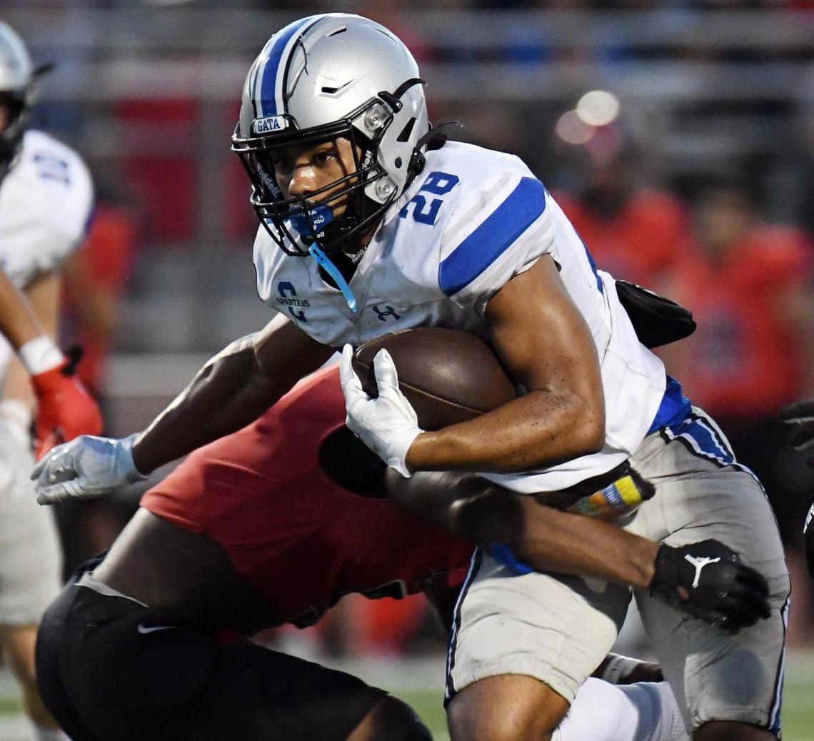 Centenial’s Elijah Zeh, center breaks the tackle of Burleson’s Cayden Cartmill as he rushes for a first down in the first quarter during Friday’s, August 26, 2022 football game at Elk Stadium in Burleson, Texas. Special/Bob Haynes
