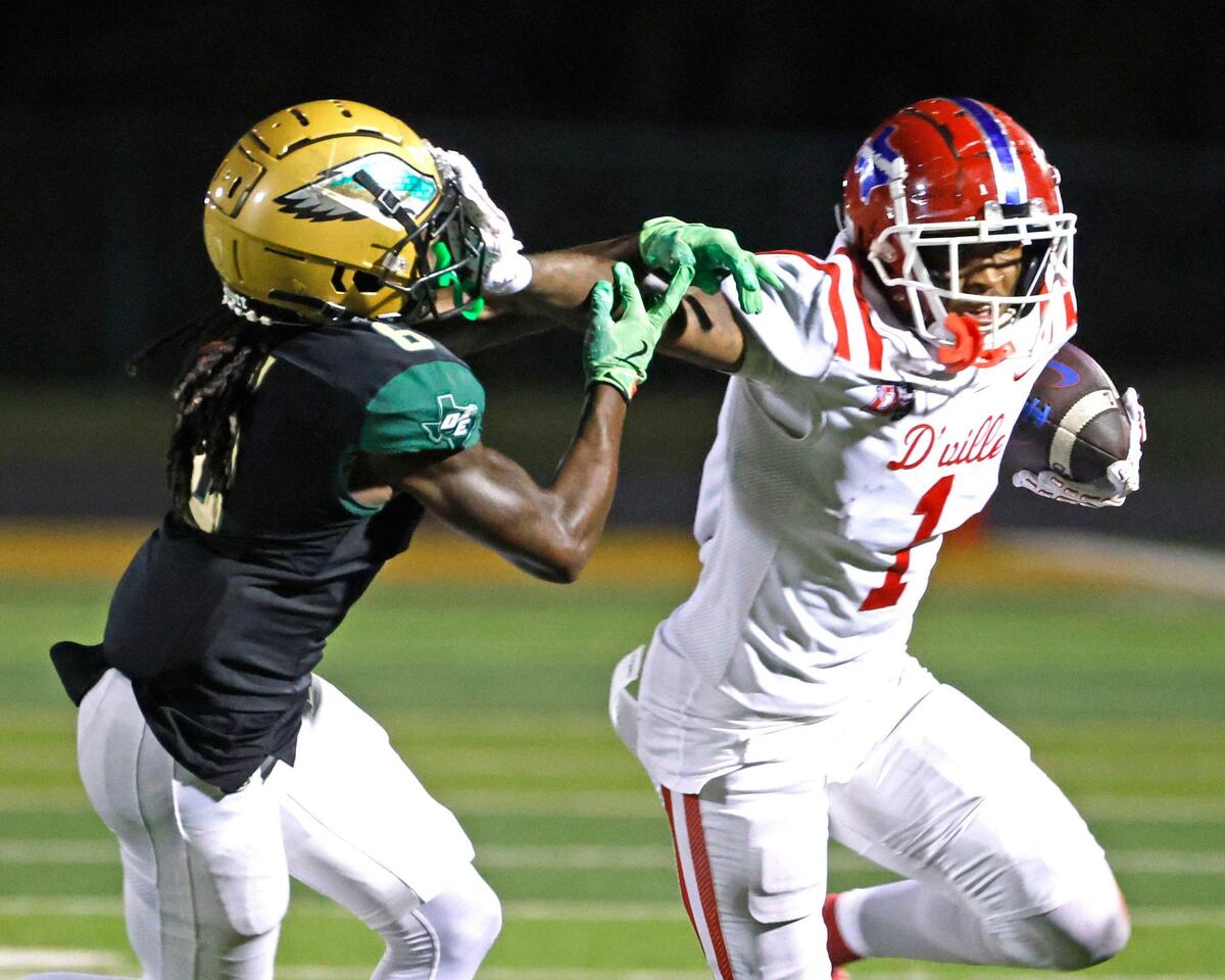 Duncanville wide receiver Dakorien Moore (1) stiff arms DeSoto defensive back Caleb Holmes (6) after the catch for a long gain during a District 11 6A football game at Eagle Stadium in DeSoto, Texas, Friday, Oct. 11, 2024.
