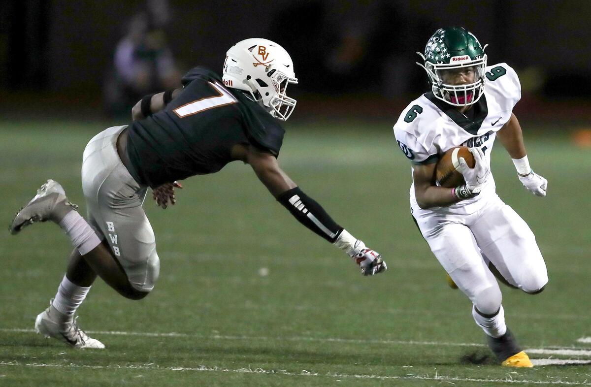 Arlington running back BJ Rogers (6) get past Arlington Bowie defensive back DeAnte Betts (7) during the first half, Friday night, October 11, 2019 played at Wilemon Field in Arlington, TX.