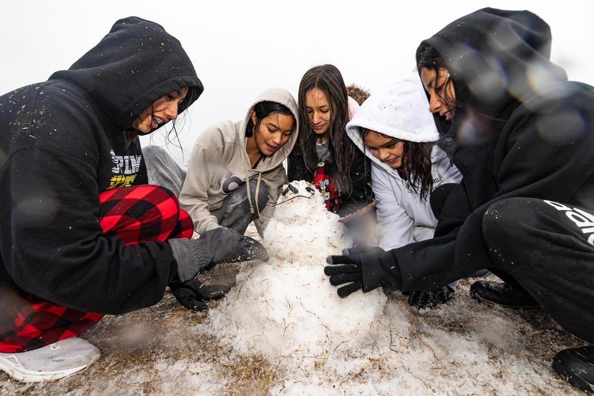 Stripling Middle School students Mia Rodriguez, 14, Cecilia Rico, 14, Ariana White, 14, Mia Rico, 12, and Isabella Rodriguez, 14, build a snowman in their neighborhood park in Southwest Fort Worth on Thursday, Jan. 9, 2025. The winter storm led to all Fort Worth ISD schools to close for the rest of the week.