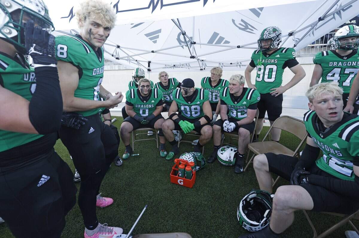 Dragon defensive players rest on the bench as the offense plays Denton Ryan during the second half of a UIL Class 6A Division II Quarterfinal on Saturday Dec. 06, 2025 at Crowley ISD Multi-Purpose Stadium in Fort Worth, Texas.