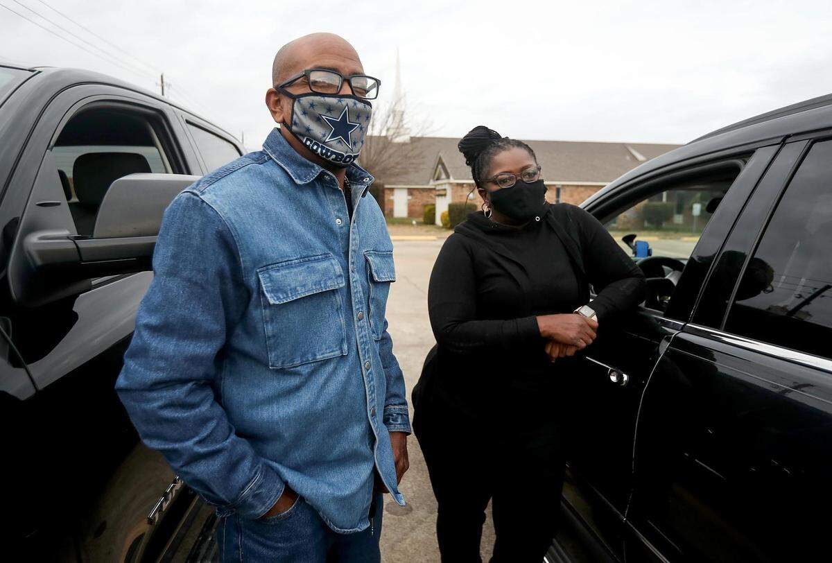 Carlos Sanders, left, and Paula Warren-Houston gather before caravanning to their longtime friend Thomas Dixon’s home on Friday, December 18, 2020.