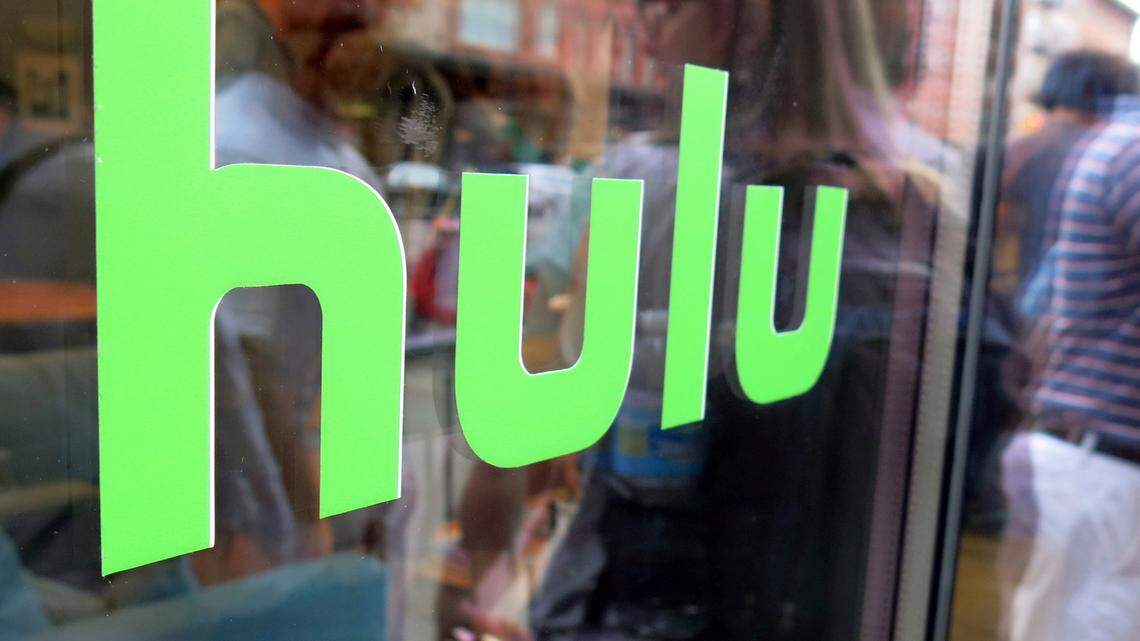 This June 27, 2015, file photo, shows the Hulu logo on a window at the Milk Studios space in New York. Hulu is hiking its price for live TV from $54.99 to $64.99 starting Dec. 18.