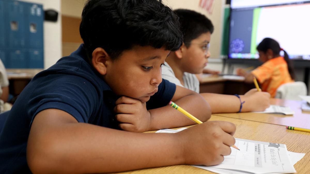 Jaime Conde works on a problem during a fourth-grade math class in the summer learning program at Rufino Mendoza Elementary School on June 12 in Fort Worth.