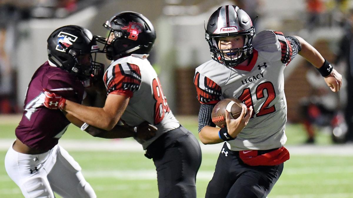 Mansfield Legacy quarterback Cam Clark, right, keeps the ball as he rushes for a touchdown to take a 27-15 lead over Mansfield Timberview during the fourth quarter of Friday’s  September 28, 2018 football game at Vernon Newsom Stadium in Mansfield. Legacy went on to win 27-22.