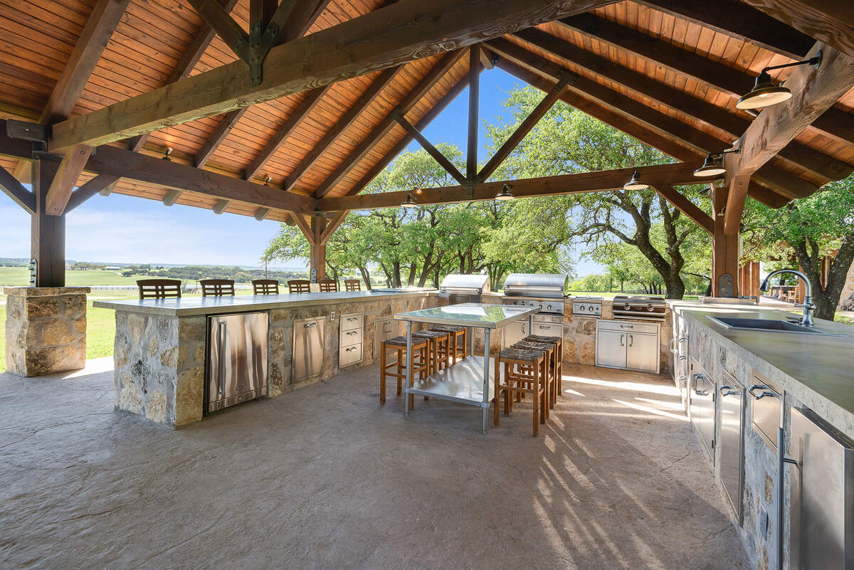 Bosque Mountain Ranch is equipped with a full outdoor kitchen with multiple grills and smokers, as well as a pizza oven and plenty of outdoor seating.