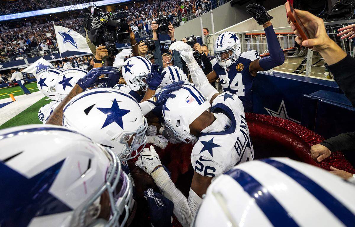 The Dallas Cowboys celebrate cornerback DaRon Blands’ record breaking fifth pick-six of the season against the Washington Commanders on Thursday, November 23, 2023, at AT&T Stadium in Arlington.