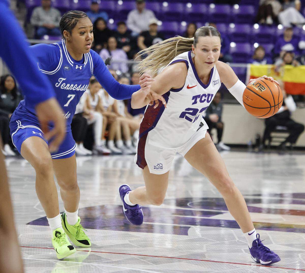 TCU guard Maddie Scherr (22) drives the lane on Tennessee State guard Icesis Thomas (7) during the second quarter of a NCAA women's basketball game between Tennessee State and TCU at Schollmaier Arena in Fort Worth, Texas, Wednesday Nov. 12, 2025.