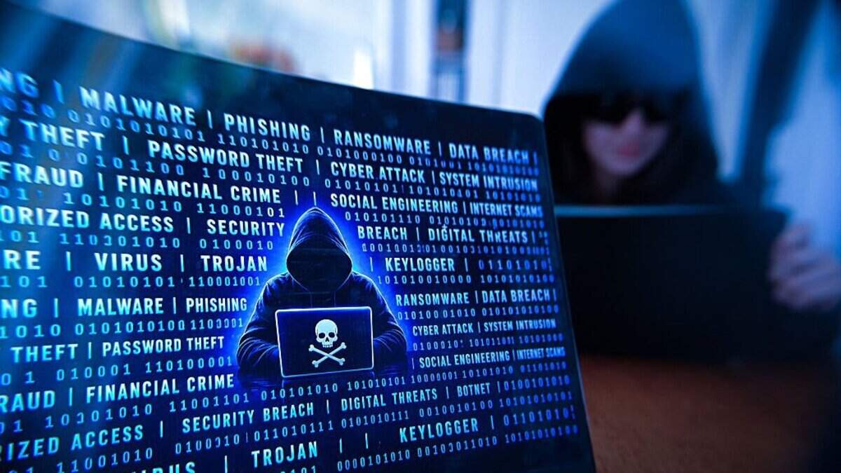 ILLUSTRATION of cybercrime and hacking activity with a laptop displaying a pirate symbol while a hooded person uses a digital tablet in a dark environment in Paris, France, April 28, 2026. (Photo by Joao Luiz Bulcao / Hans Lucas / AFP via Getty Images)