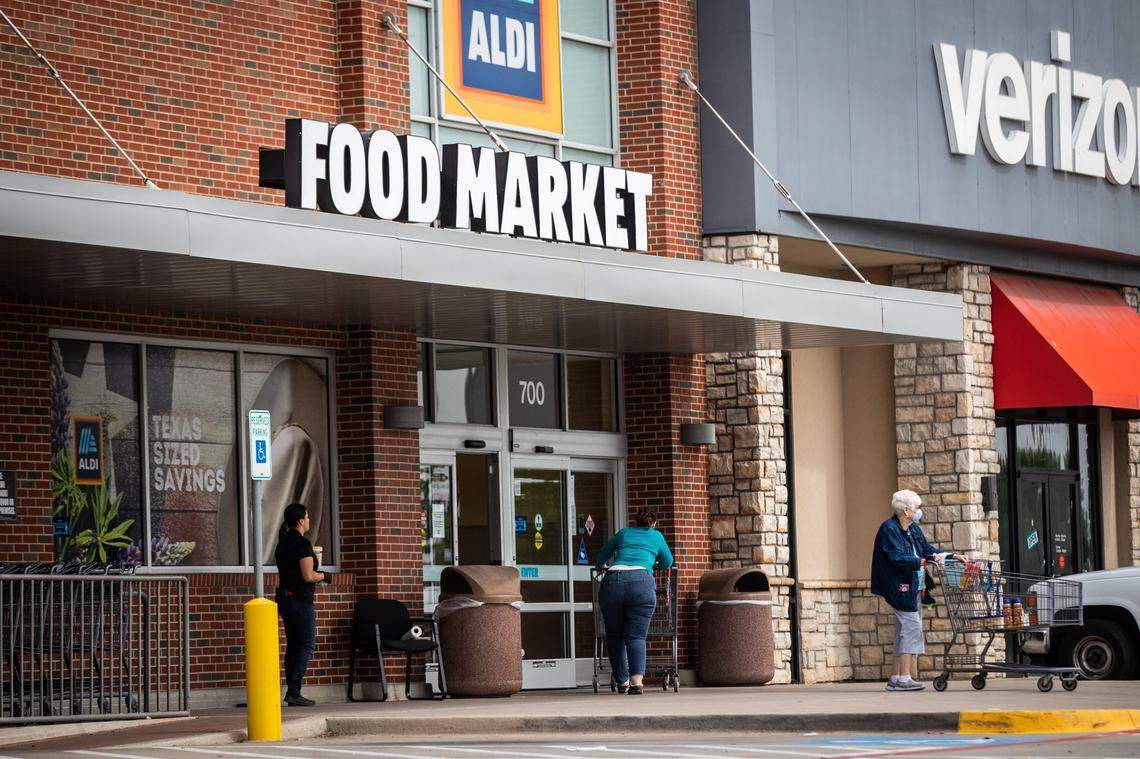 Shoppers come and go from an Aldi in Fort Worth.