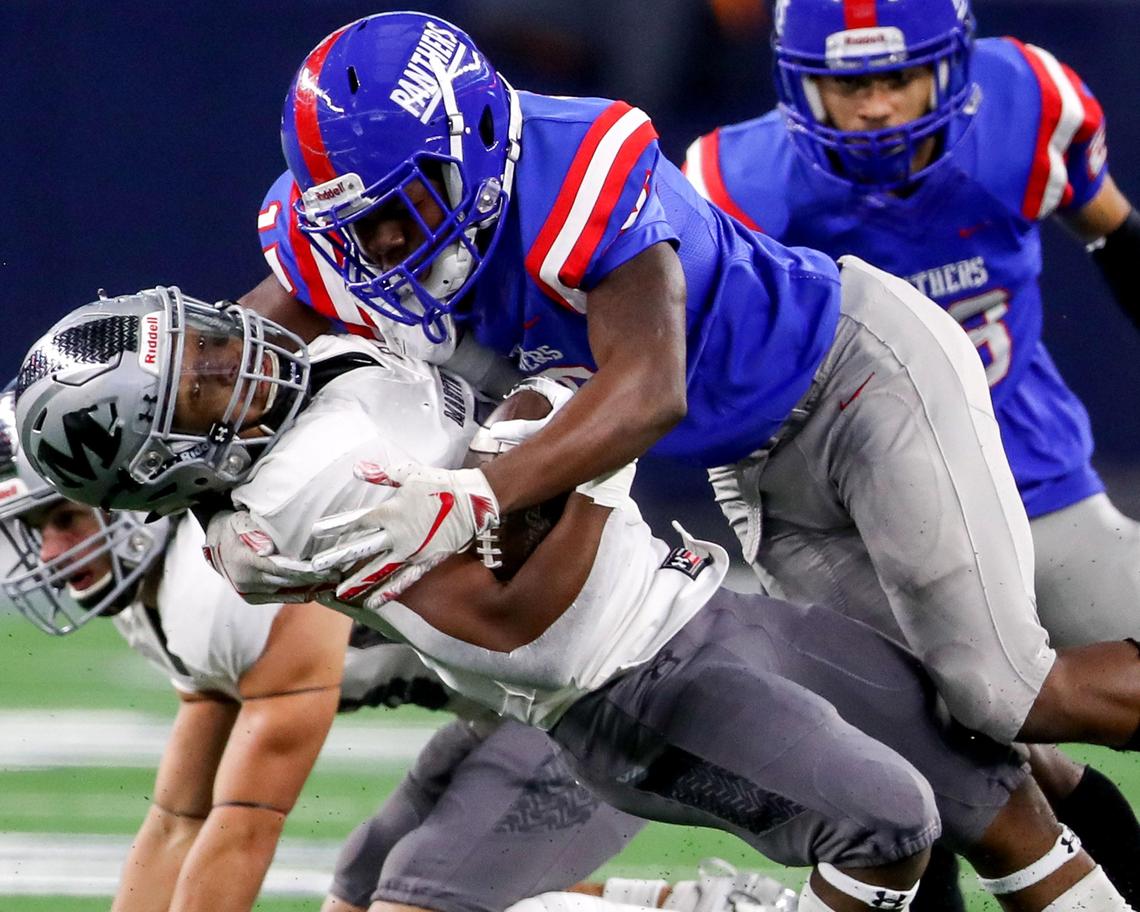 Duncanville linebacker James Roberts Jr (15) puts a big hit on Arlington Martin running back Dwayne Williams (3) during the first half of their 6A Division I Regional Round High School Football playoff game at AT&T Stadium in Arlington, Tx Friday November 29, 2019.