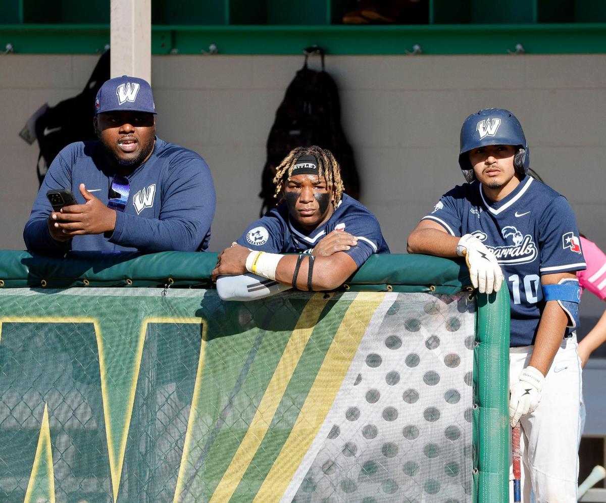 Wyatt catcher Jorvorskie Lane (2) watches third inning offense with head coach Quinlin D. Germany and team mate Pascual Ramirez (10) during a UIL baseball game at Benbrook High School in Fort Worth, Texas, Thursday, Feb. 22, 2024.