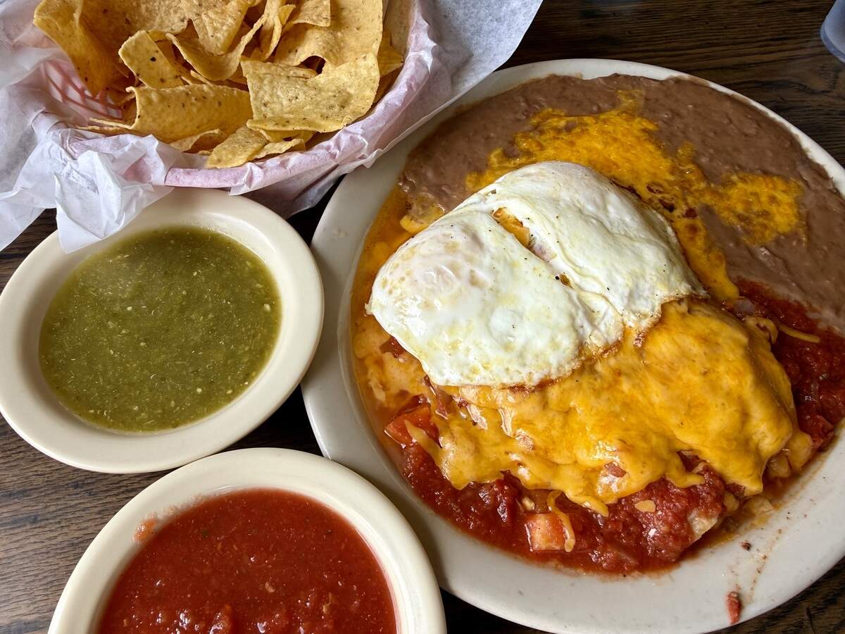 Enchiladas rancheras with eggs and refried beans, a breakfast platter at El Sombrero Restaurant in Saginaw, Texas, seen June 6, 2026.