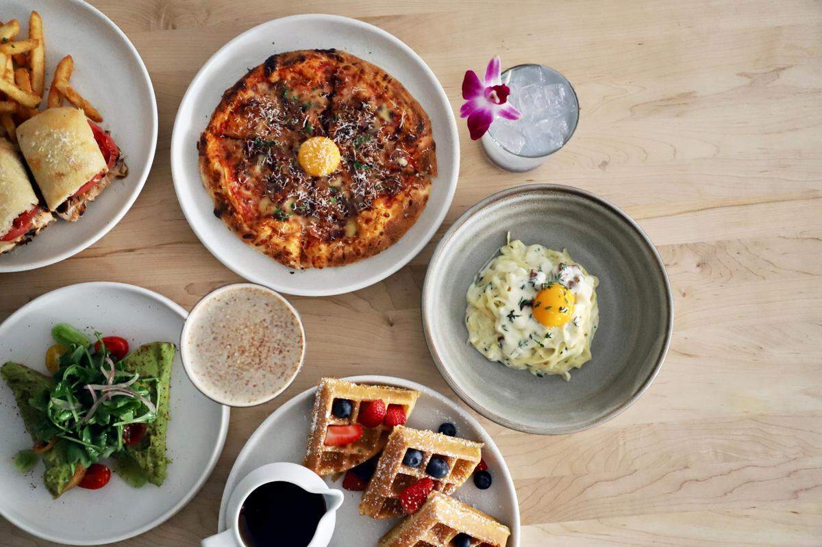 Brunch items at Il Modo include a pizza, waffle, avocado toast and chicken sandwich.