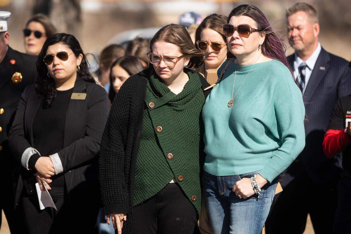 Lauren Quilantan, daughter of Michael Wells, center, listens to speakers at a memorial a year after the deadly I-35W crash Friday, Feb. 11, 2022, at Riverside Park in Fort Worth.